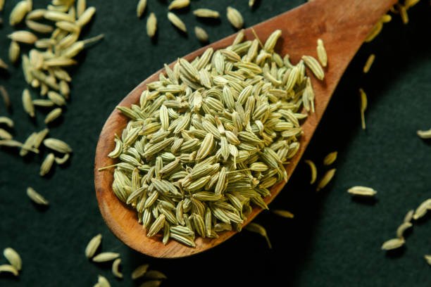close up fennel seed in wooden spoon