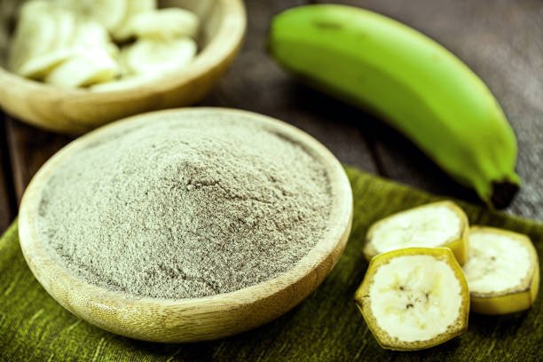 green banana flour on rustic wooden table, healthy homemade flour